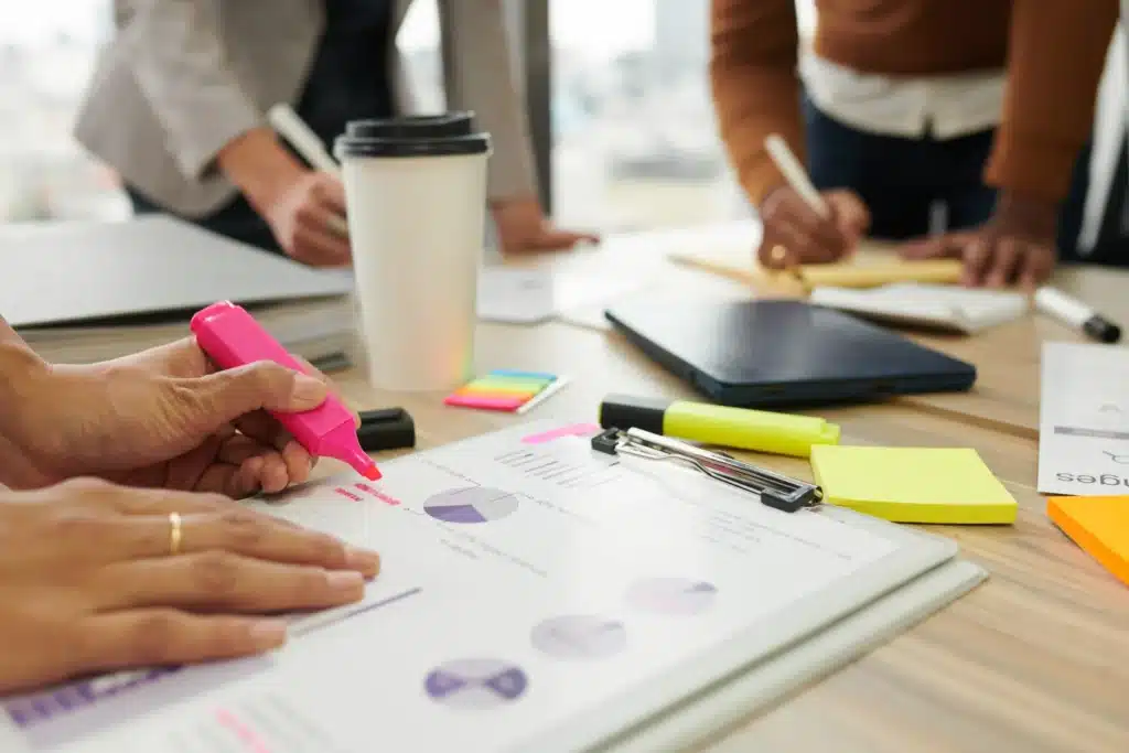 Employees taking notes of essential questions for interview