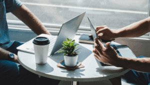 A pair of people at a table, focused on their laptops, suggesting a productive meeting or study session.